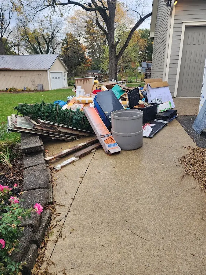 Dumpster being loaded with debris for Residential Dumpster Rental in East Granby